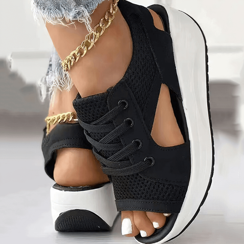 Black sports open toe women's sandals with lace-up design, thick soles, and gold ankle chains, showcasing air mesh material.