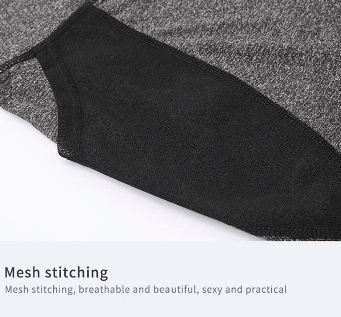 Close-up of black and gray mesh stitching on high-waisted quick-dry sports shorts for women, highlighting breathable material.