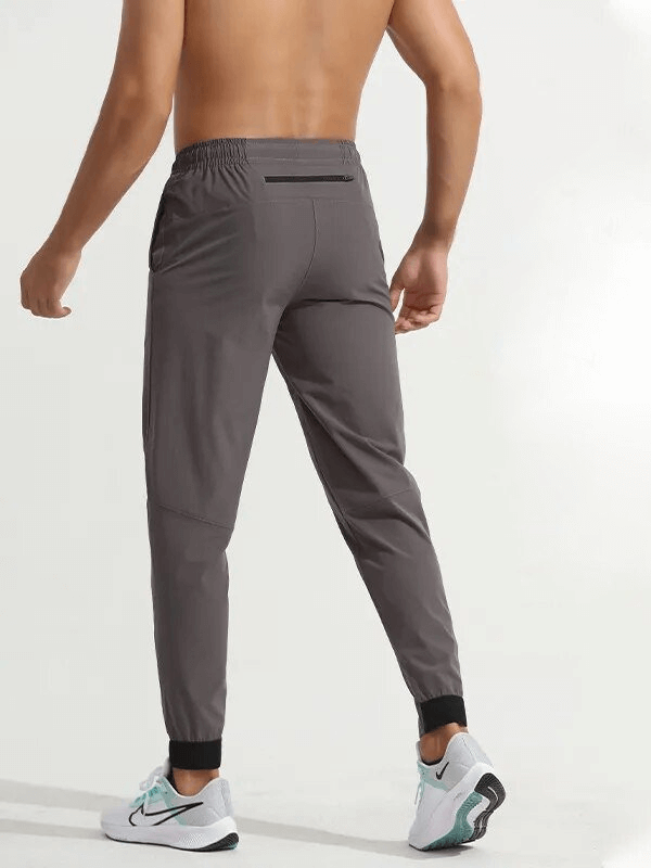 Back view of Sports Quick-Drying Men's Pants with zippered pocket, elastic waist, and snug fit for elite runners, style SF1573.