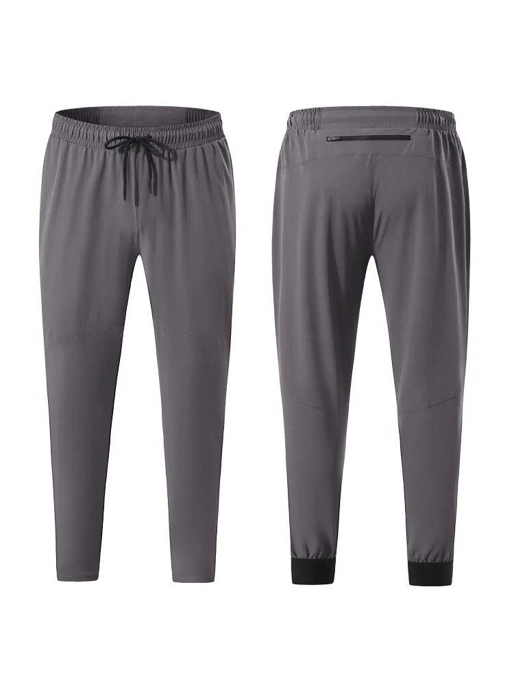 Sporty quick-drying men's pants with zippered pockets for comfort and utility, ideal for running and workouts. Model SF1573.