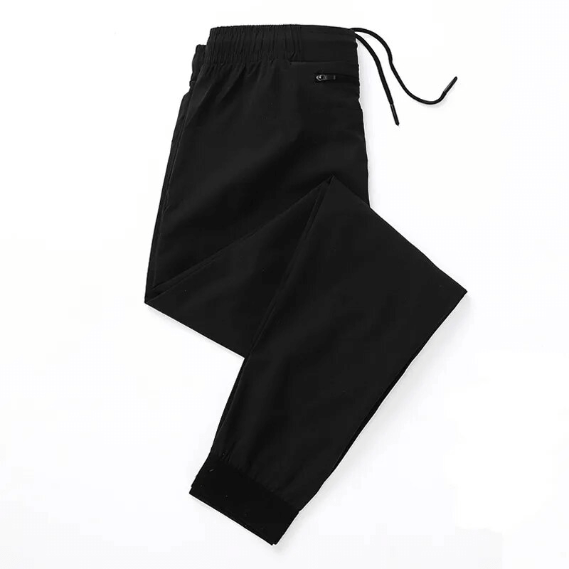 Black quick-drying men's sports pants with zippered pockets and elastic waist - perfect for runners and workouts. Model SF1573.