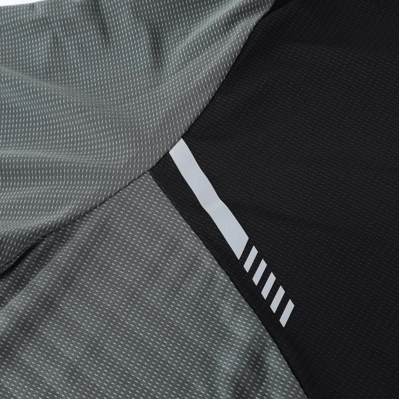 Close-up of a grey and black sports pullover fabric with quick-drying polyester texture and white stripes.