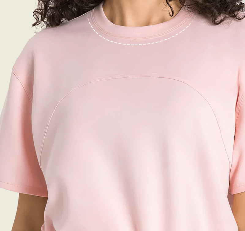 Pink sports crop T-shirt with short sleeves and adjustable hem, designed for female fitness enthusiasts; ideal for yoga and running.