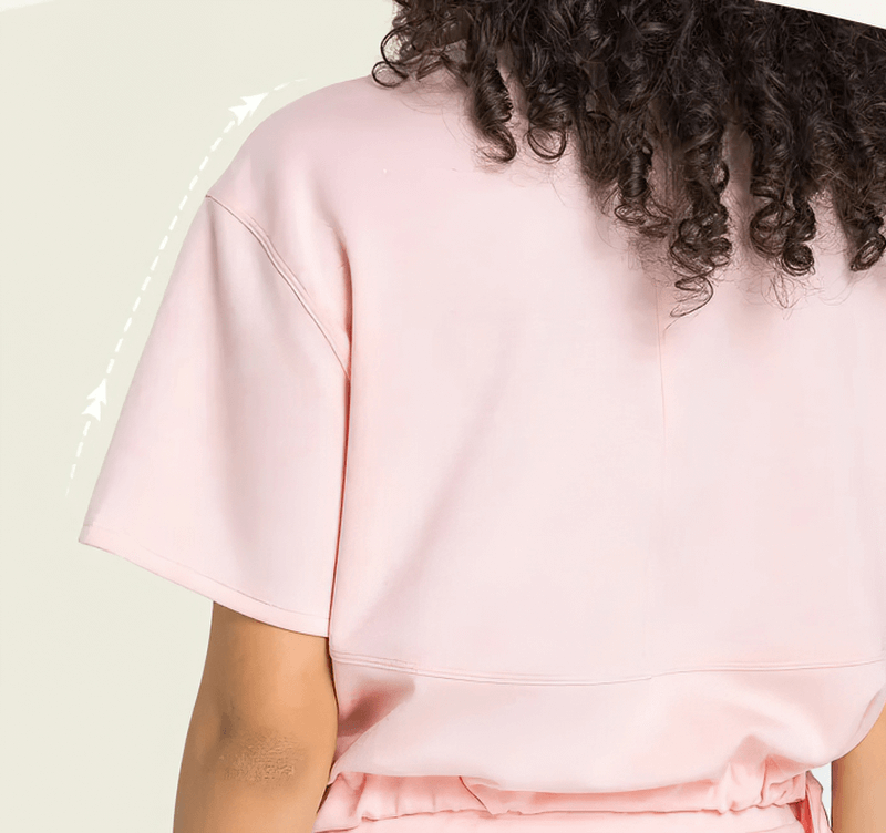 Back view of a pink sports short sleeve crop T-shirt with adjustable hem, highlighting breathable and quick-dry fabric ideal for fitness.