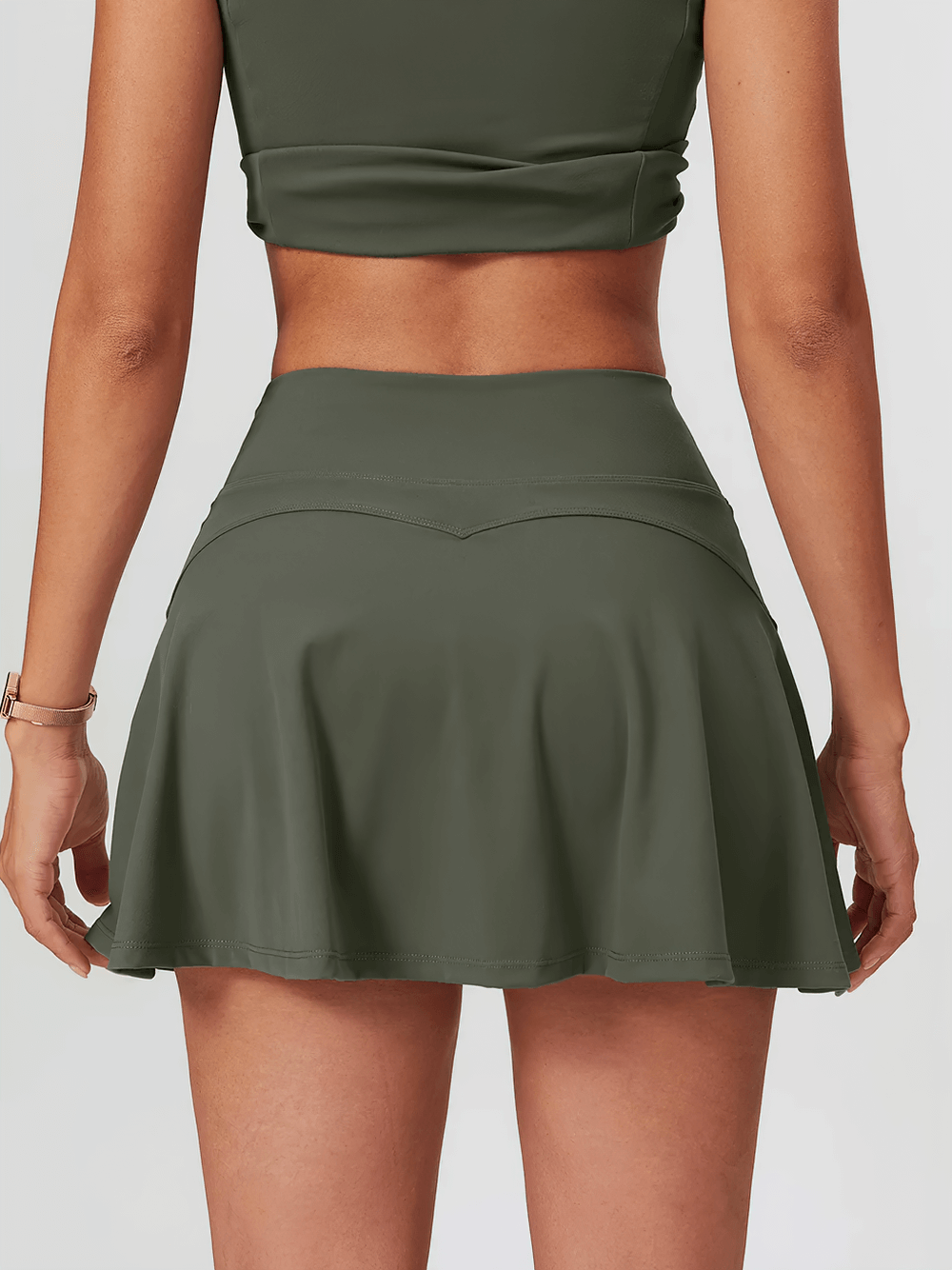 Back view of a green sports skirt with built-in shorts, perfect for tennis, yoga, and gym workouts.