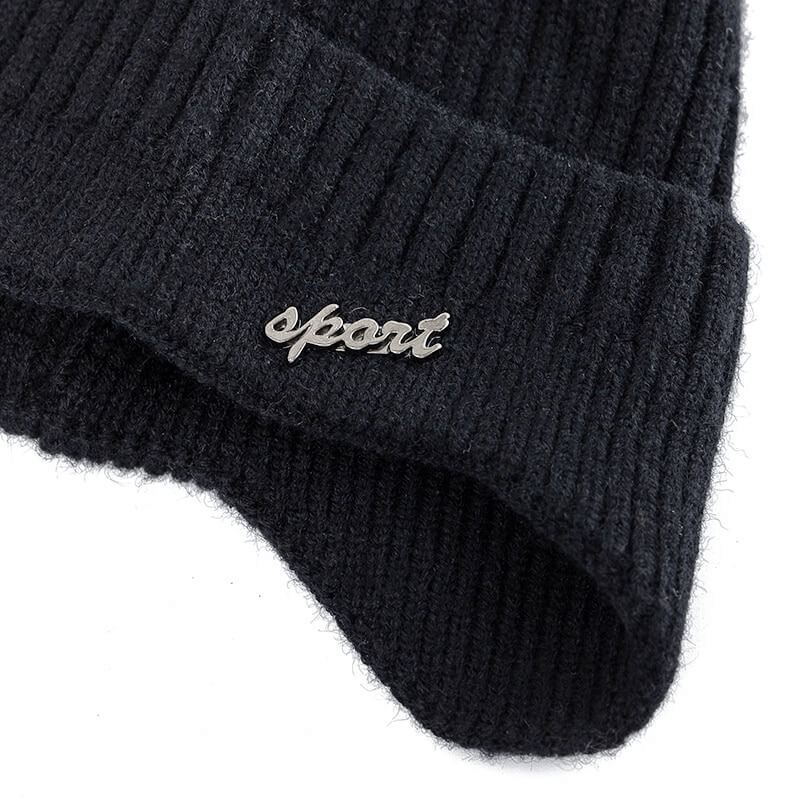 Close-up of a black knitted ski beanie with 'sport' emblem, made from soft acrylic for unisex fashion and outdoor activities.