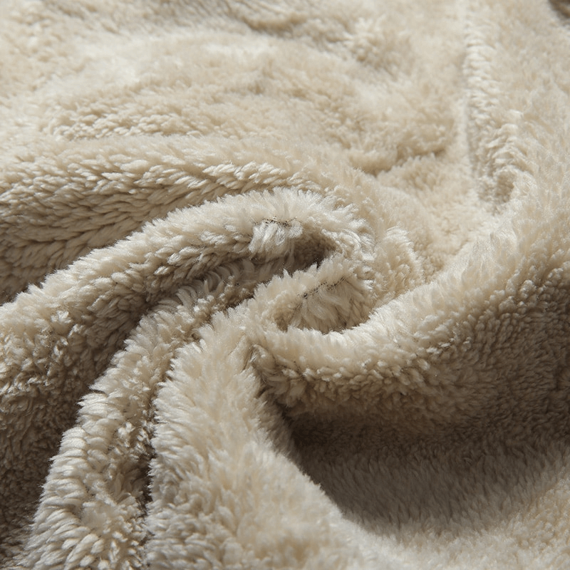 Close-up of soft beige fleece fabric from sports men's pants, showcasing plush texture and warmth for winter wear.