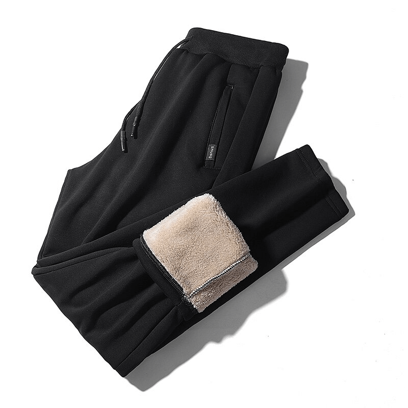 Black men's sports fleece pants with pockets, featuring a warm interior and drawstring closure, ideal for winter comfort and style.