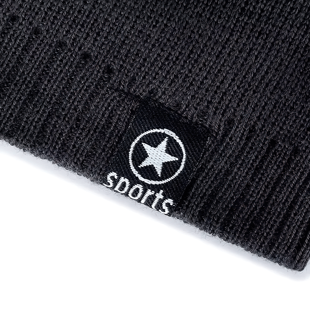 Close-up of black knitted sports beanie with star logo, perfect for outdoor adventures, featuring warm fur lining. Model SF2407.