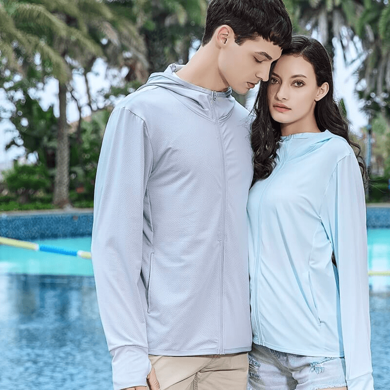 Man and woman modeling light blue sports windbreakers in a poolside setting, ideal for women's outdoor adventures and trekking.