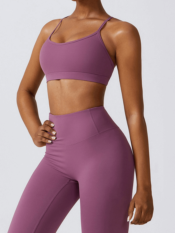 Woman in purple sportswear yoga set, featuring a breathable and stretchy 2-piece outfit ideal for various sports activities.