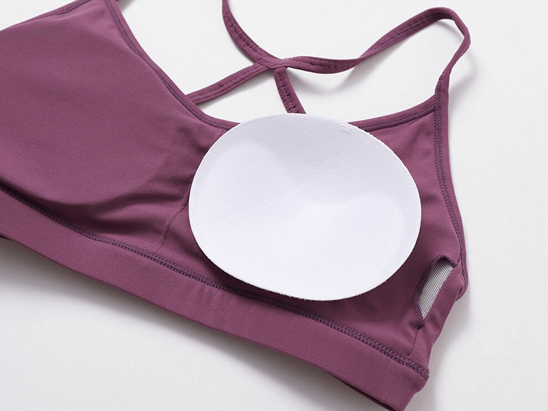 Purple sportswear yoga top with white insert pad, designed for women, featuring breathable and quick-dry nylon spandex fabric.