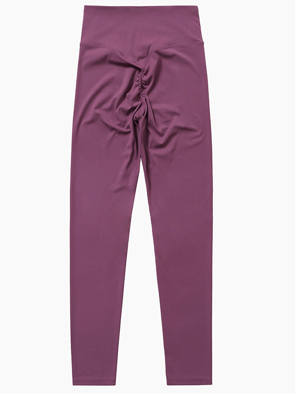 Purple women's high-waisted yoga leggings with ruched detail, made from breathable, stretchy fabric for sports and exercise.