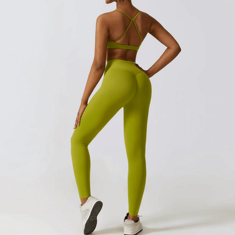 Woman wearing green two-piece sportswear yoga set for women, showcasing breathable and stretchable fabric, ideal for fitness activities.