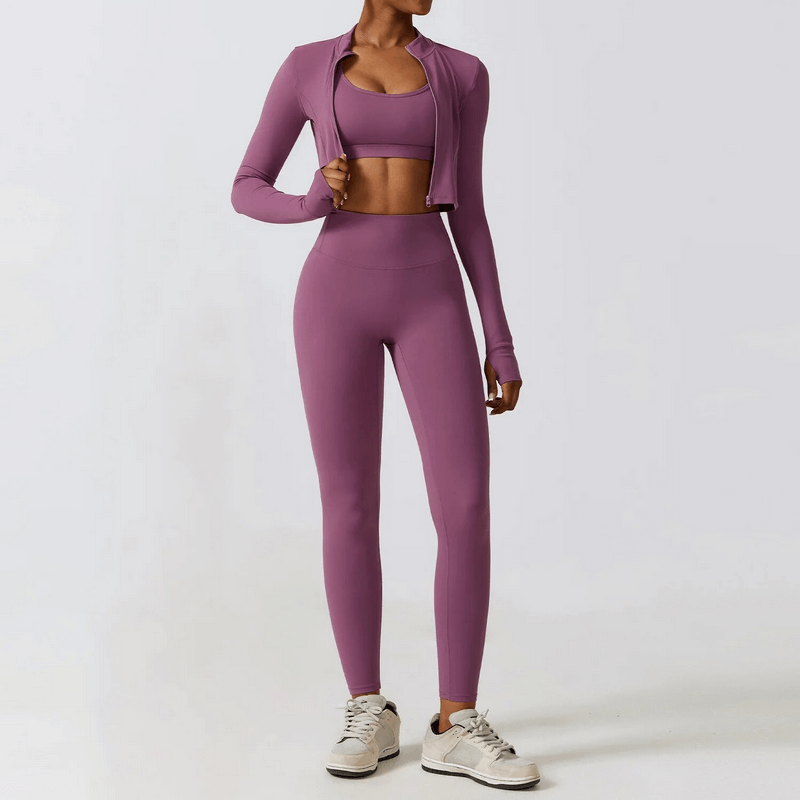 Woman in purple 3-piece yoga set, jacket, sports bra, and leggings, ideal for fitness and yoga with quick-dry technology.