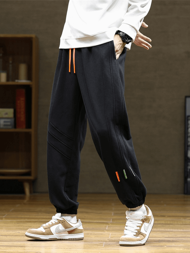 Sporty baggy casual joggers pants for men with side pockets, featuring a comfortable fit, drawstring closure, and full-length design.