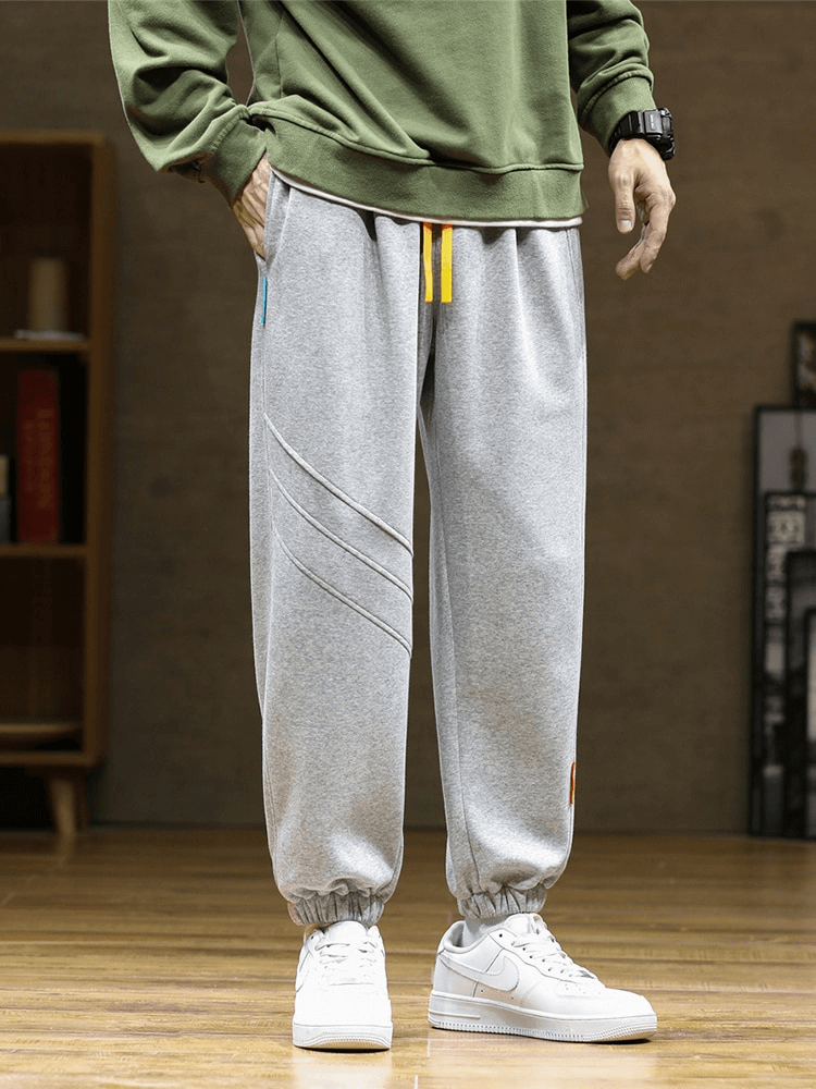 Men's sporty baggy casual joggers with side pockets, drawstring closure, and flat-front in gray. Perfect for everyday casual wear.