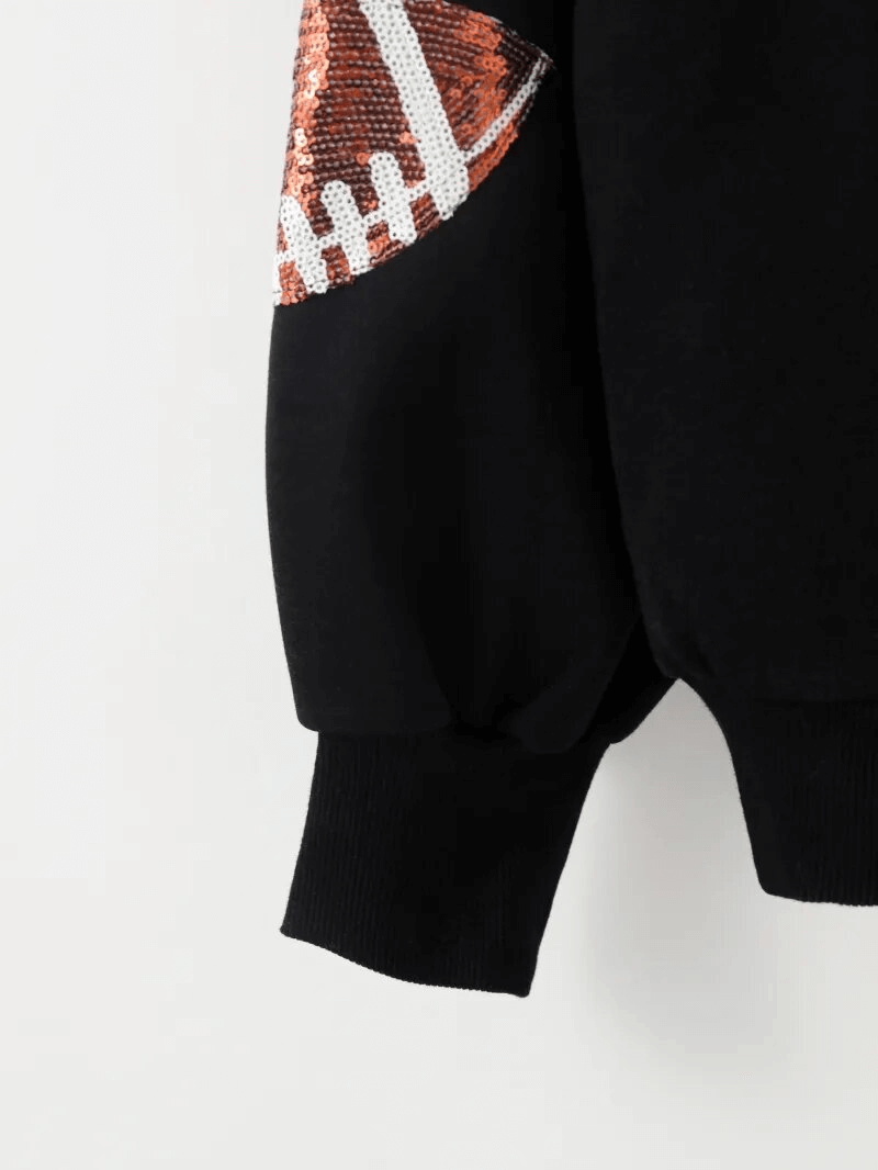 Black women's hoodie with a football sequin design on the sleeve, featuring ribbed cuffs and sporty style for casual wear.