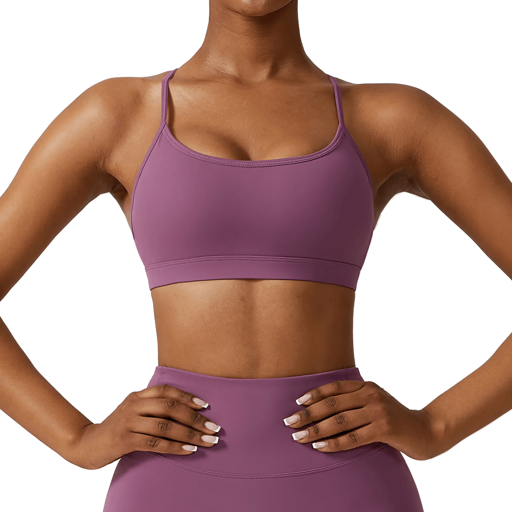 Stylish strappy back sports bra in purple, perfect for yoga and fitness, featuring a seamless design and moisture-wicking fabric.