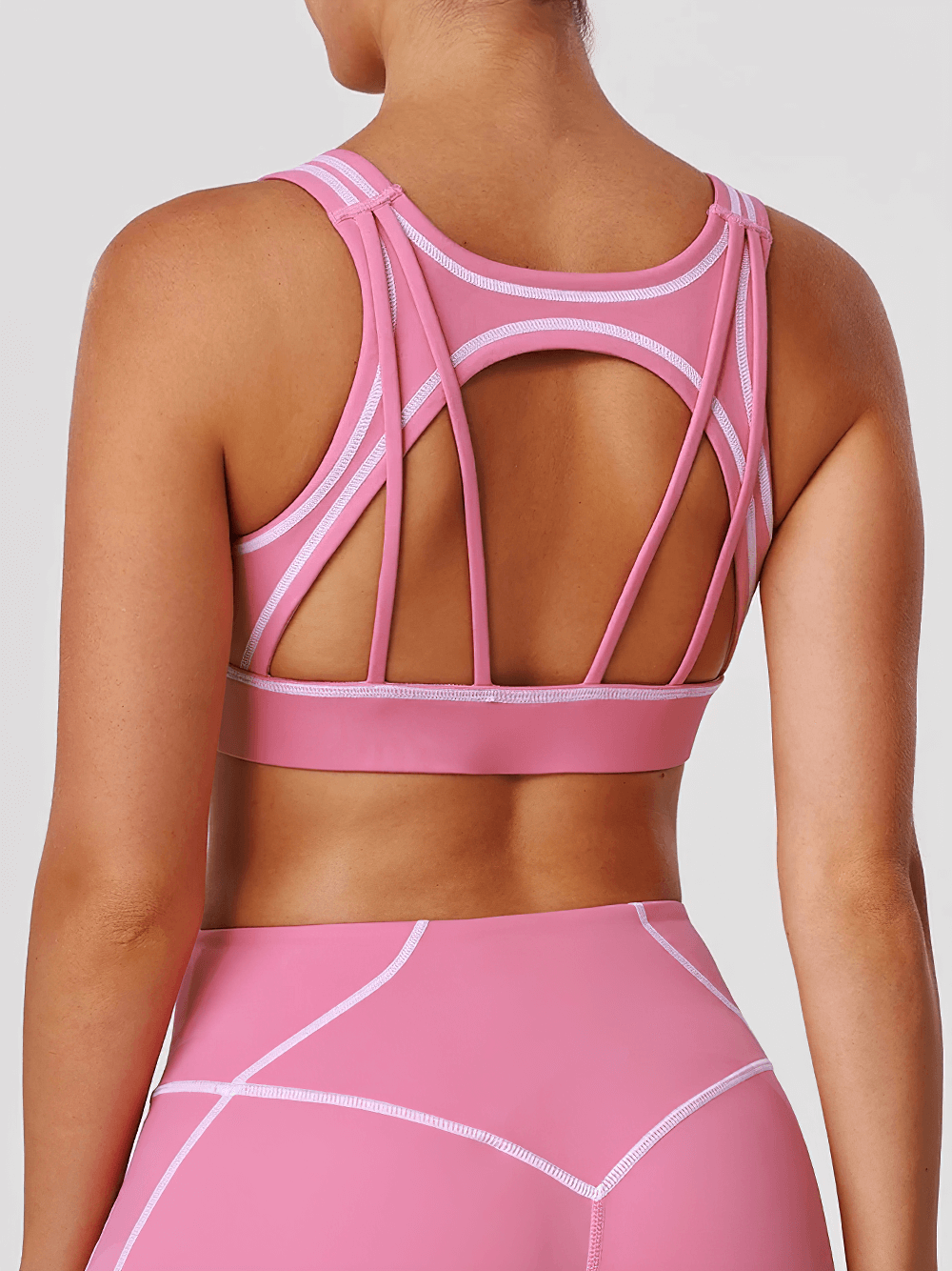 Strappy Back Sports Bra with Removable Pads - SF4062 in pink, showcasing multi-strap design and contrast seams for workout flexibility.