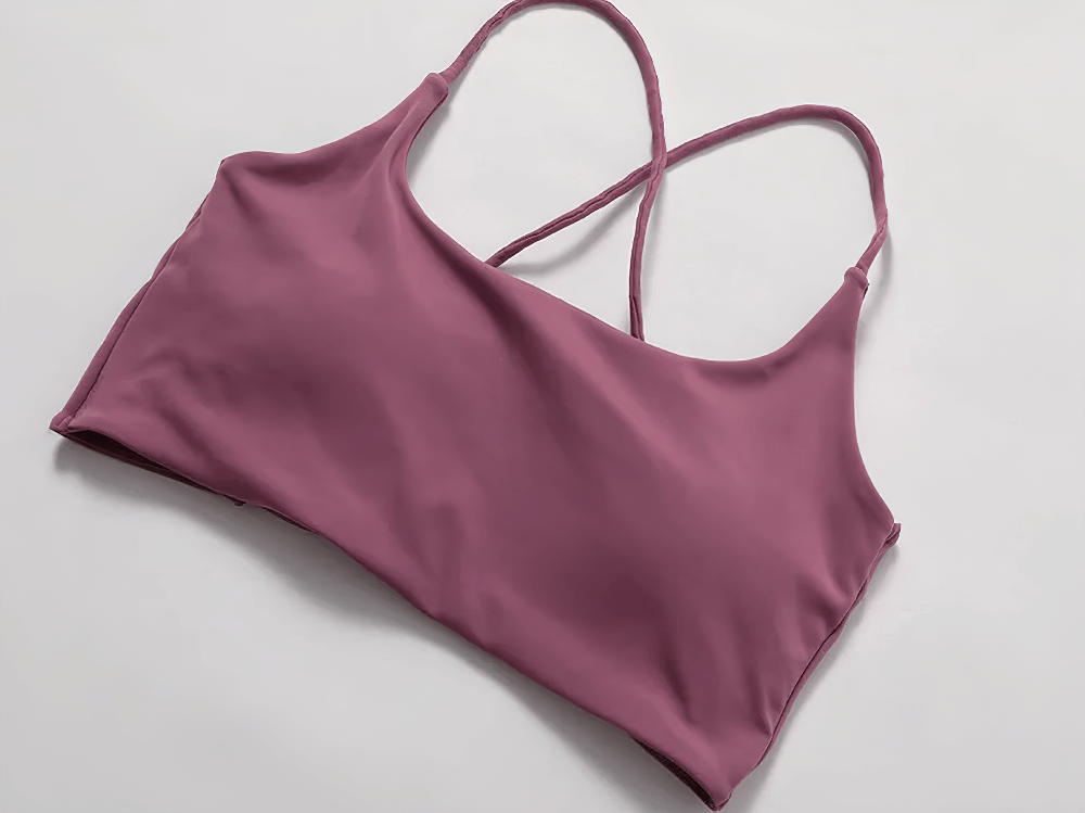 Strappy cross-back sports bra SF2451 in pink, sleek design for women, perfect for workout or yoga, moisture-wicking fabric, light support.