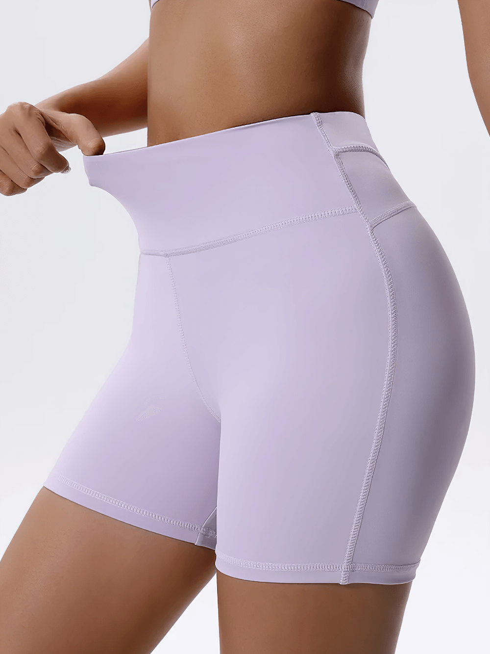 High-waist biker shorts in light lavender, showcasing snug fit and stretchy fabric for optimal movement during workouts.