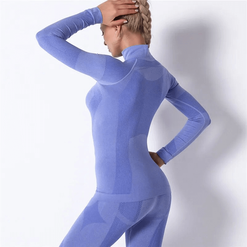 Woman wearing a stretchy seamless long-sleeve sports top in blue, perfect for yoga and high-performance activities.