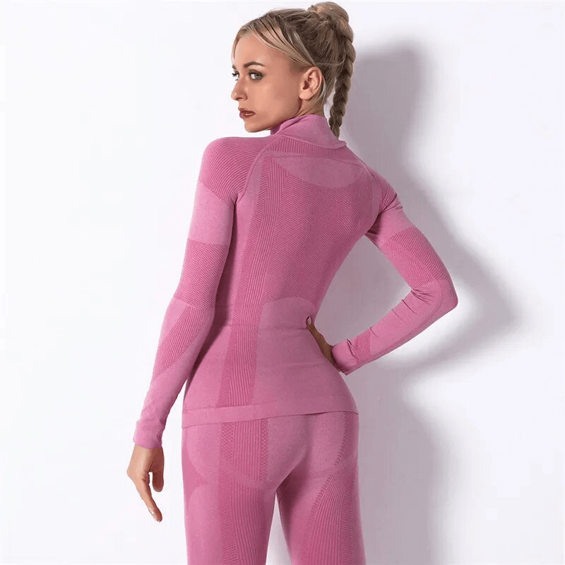 Pink stretchy seamless long sleeves sport top for women, designed for yoga with breathable nylon and soft full-length sleeves.