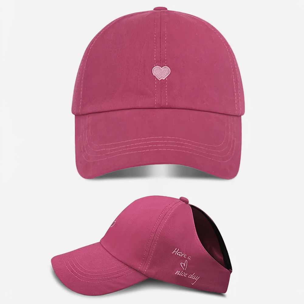 Pink adjustable baseball cap with heart design and 'Have a nice day' embroidered text, perfect for casual outings.