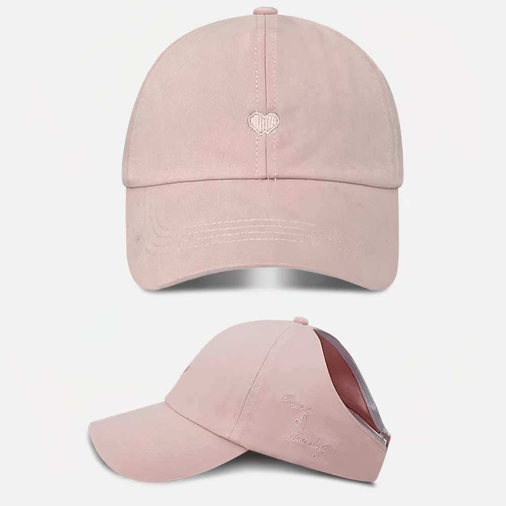 Trendy pink cotton baseball cap with heart detail and adjustable strap, perfect for style and comfort in any season.