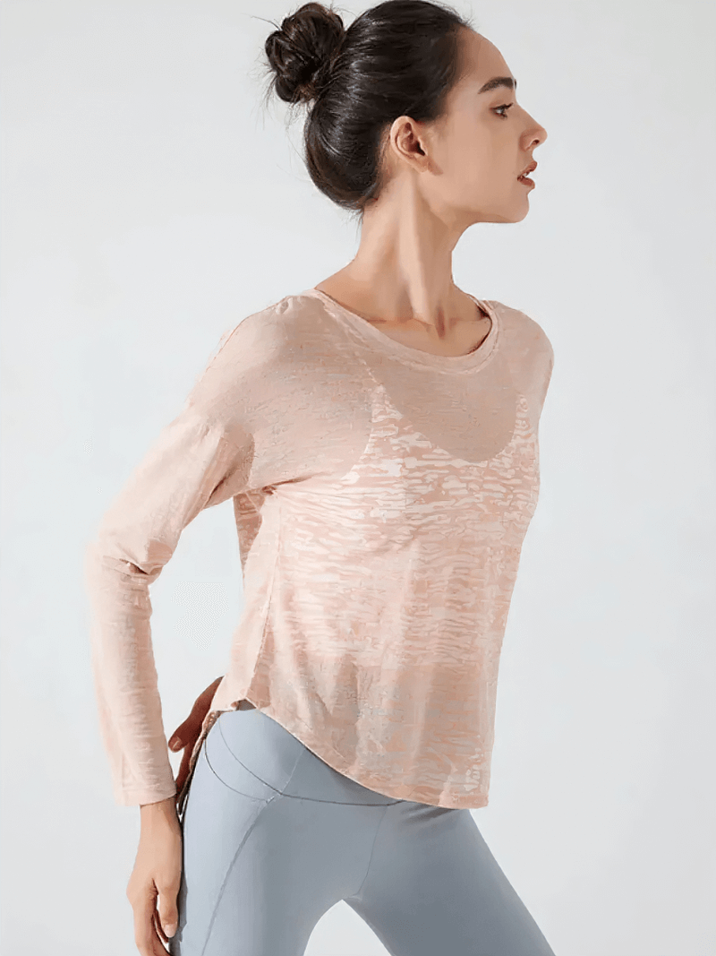 Woman wearing a stylish back-cutout see-through top for active wear, showcasing trendy fitness fashion and breathable fabric design.