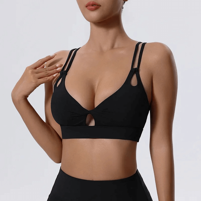Alt Tag: Stylish breathable black sports bra with unique strappy design and cut-out details, ideal for workouts and casual wear.