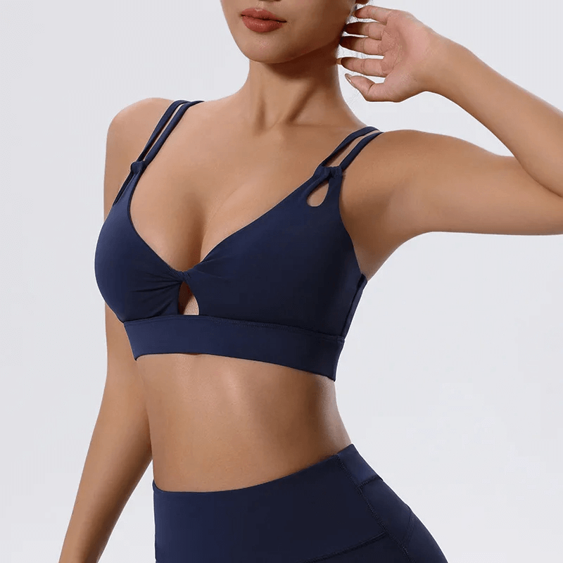 Stylish breathable sports bra with unique strappy and cut-out design, ideal for workouts and casual wear, in sleek black color, SF2084.