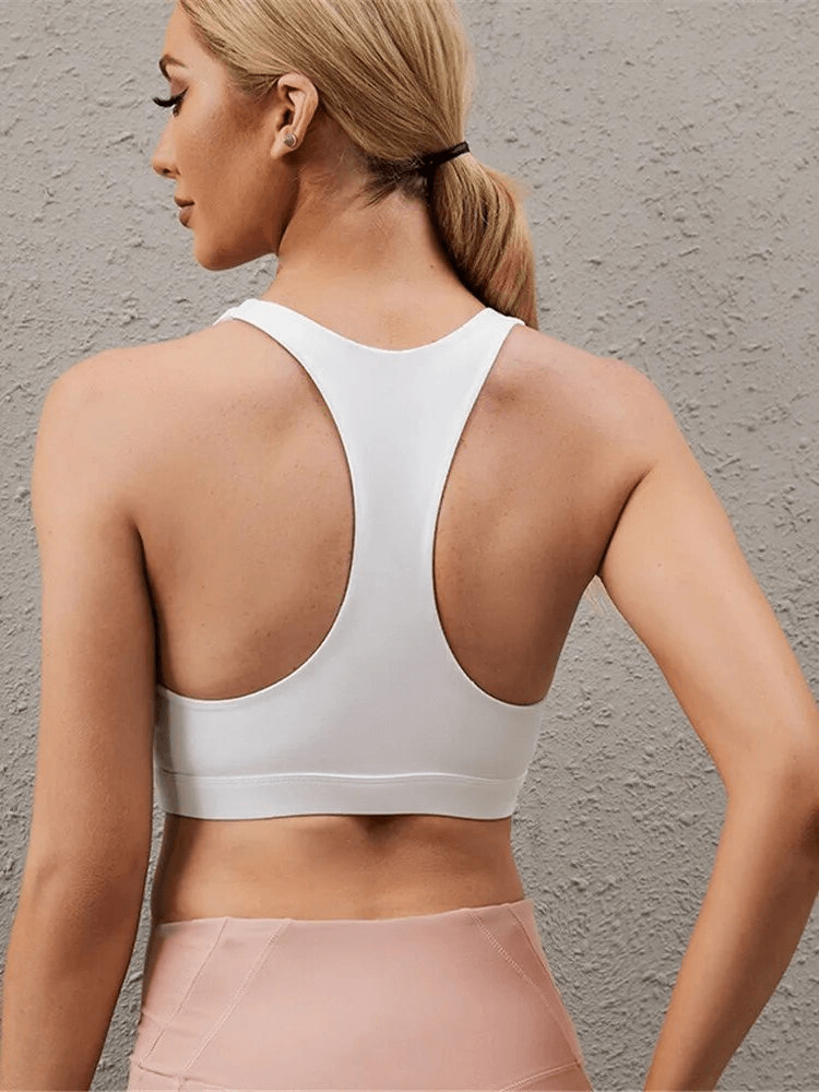 Back view of woman wearing a stylish breathable sports bra with woven front, perfect for yoga and running, made from lightweight nylon.