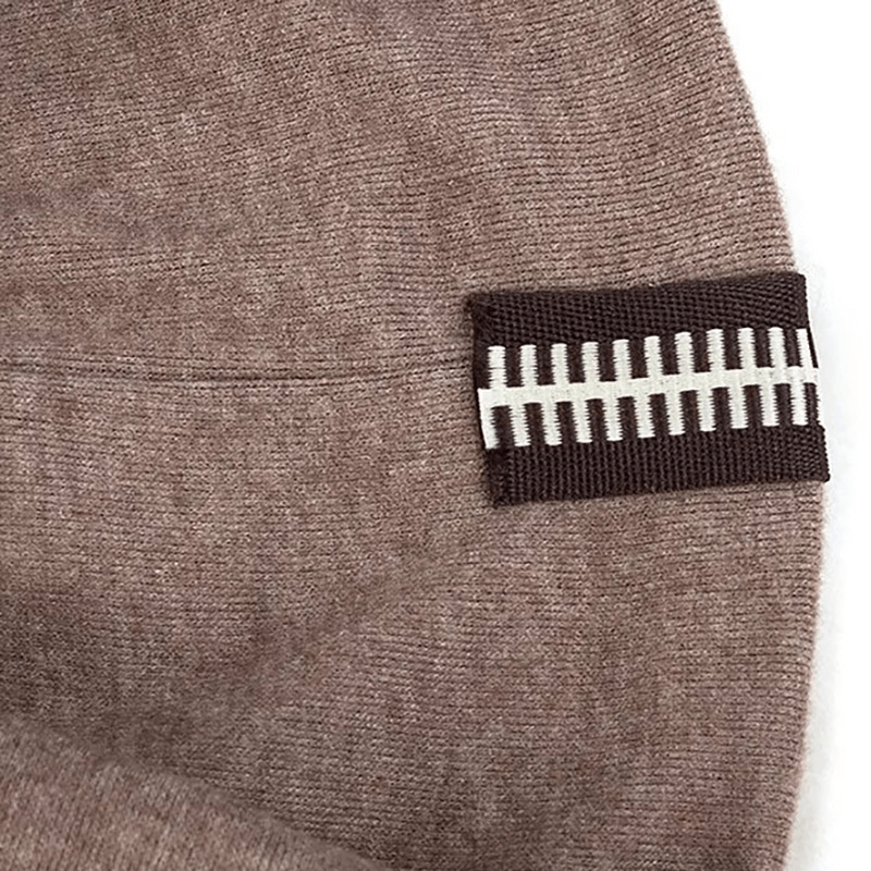 Close-up of stylish cotton soft beanie with decorative zipper and geometric pattern, unisex design, in brown fabric.