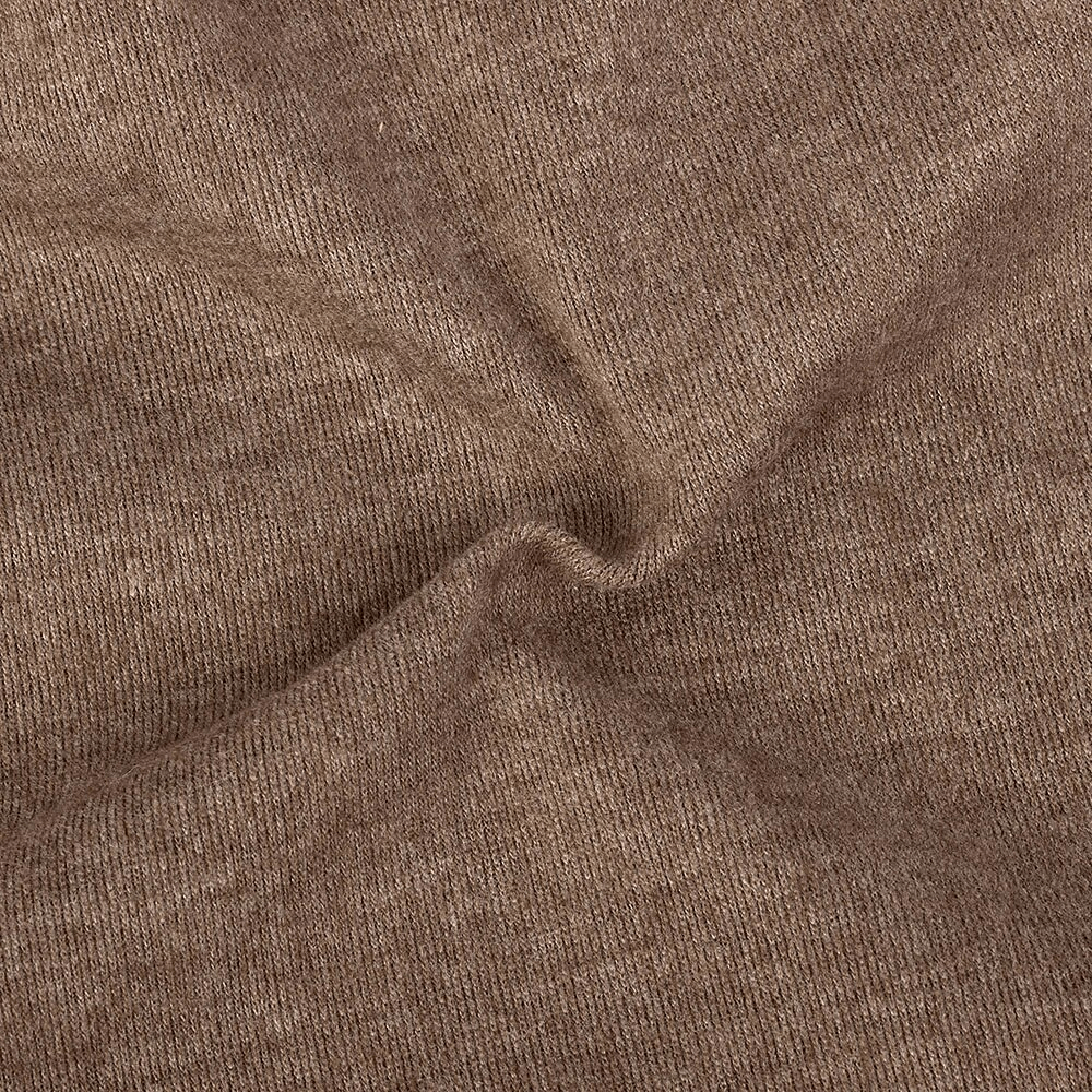 Close-up texture of soft brown cotton fabric showcasing fine knit details for a stylish unisex beanie.