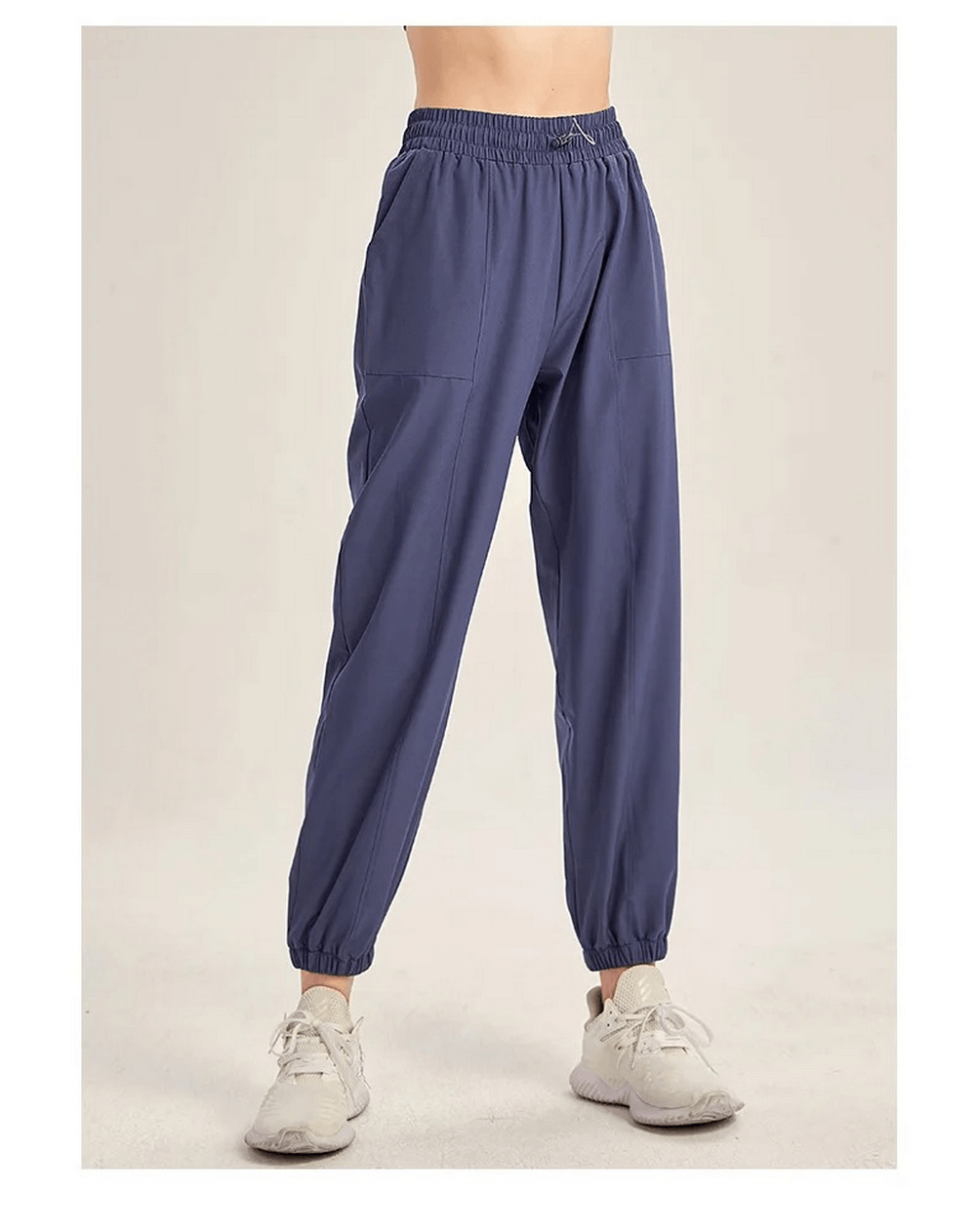 Women's blue drawstring joggers for yoga and gym, showcasing flexibility and style for running and dance. Durable athletic pants.