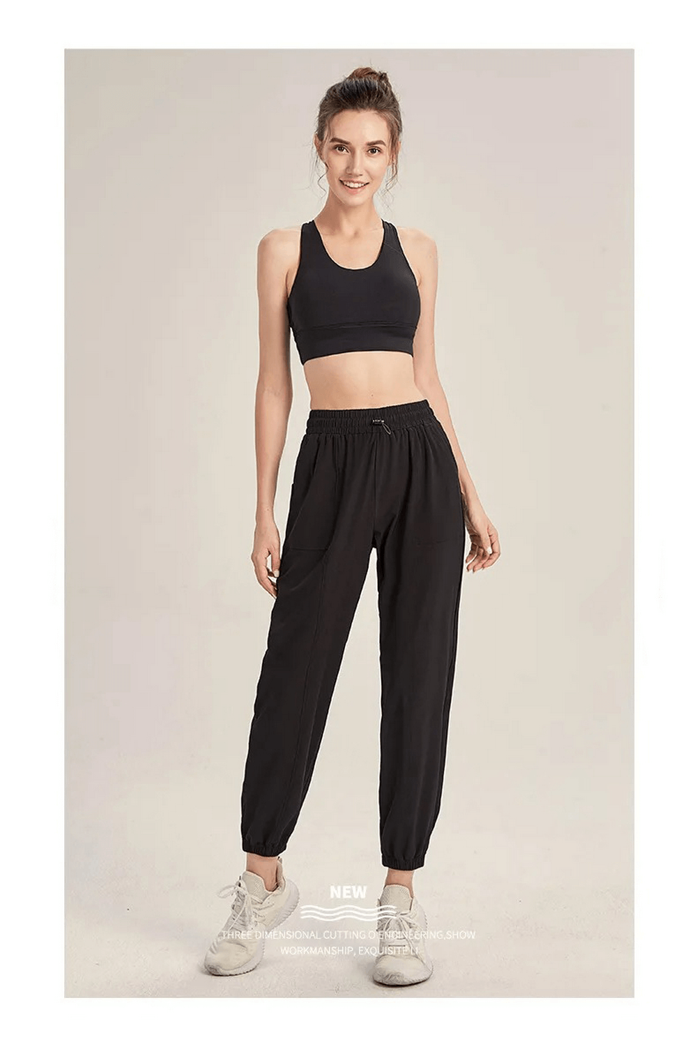 Woman wearing black drawstring joggers, perfect for yoga or gym. Sleek and flexible fit for running and dance, SF2099 style.