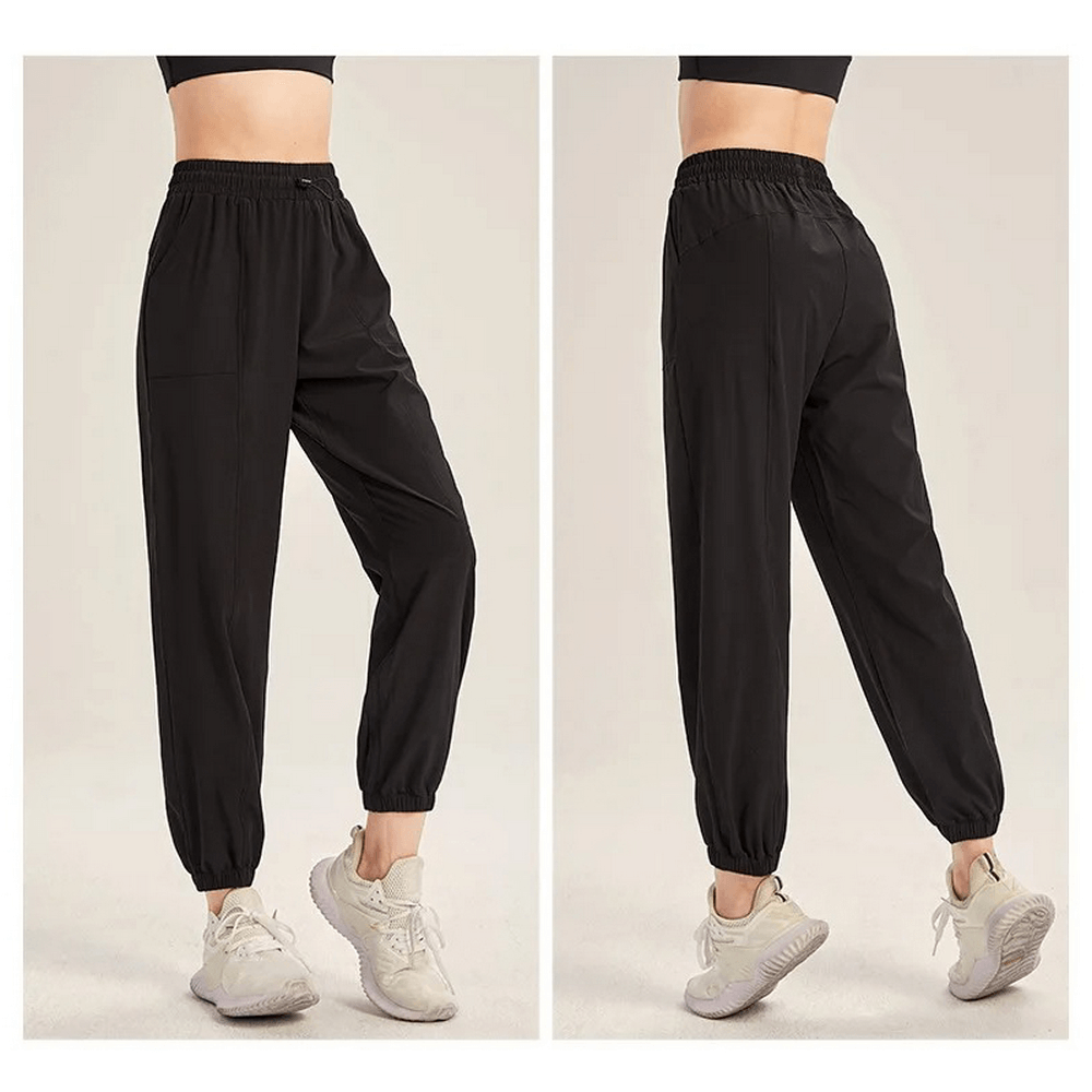 Women's black drawstring joggers for yoga, gym, running, and dance. Sleek, durable, and flexible for any exercise. Front and back view.