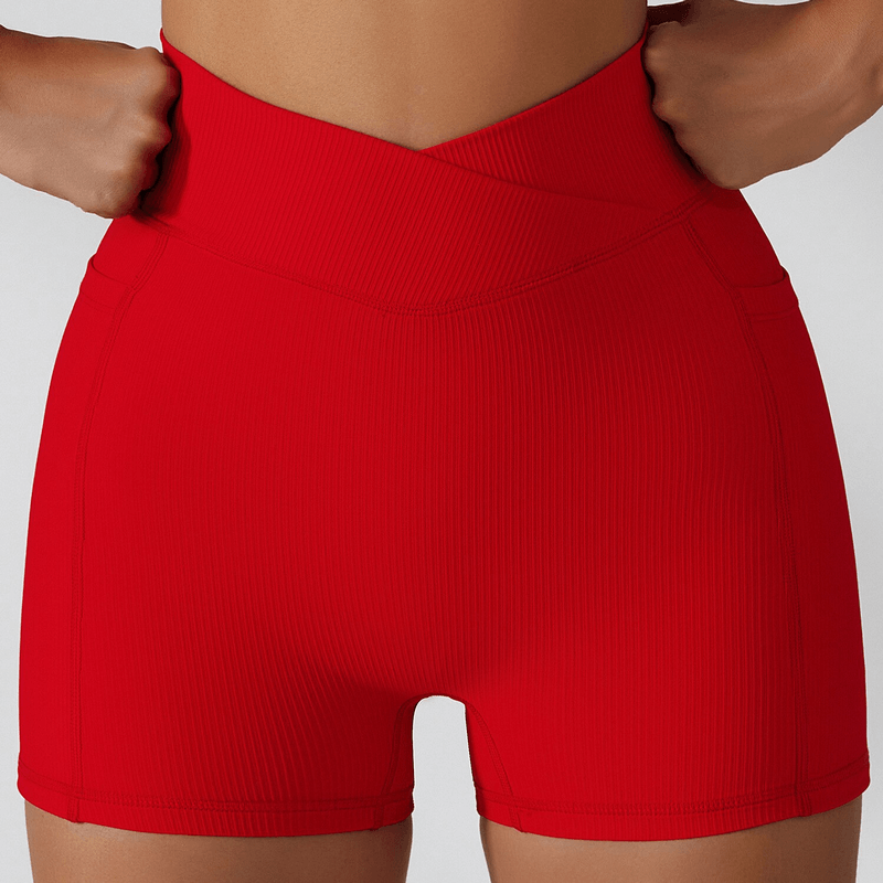 Stylish red women's shorts with elastic waist and side pockets, perfect for yoga. Made from quick-drying, eco-friendly fabric.