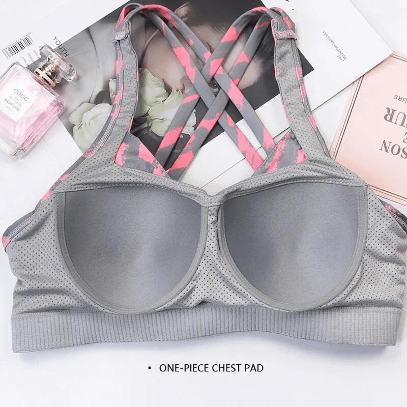 Gray stylish elastic sports bra with cross back design for women, featuring breathable nylon-spandex fabric and adjustable buckles.