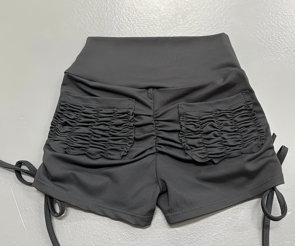 Stylish elastic sports women's shorts, high waist, black, with rear ruching detail and back pockets, perfect for fitness activities.