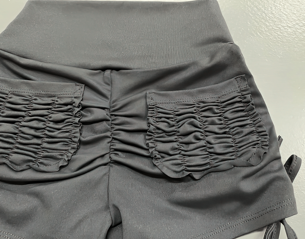 Black stylish elastic sports women's shorts with high waist and ruched back pockets, perfect for yoga and workout.