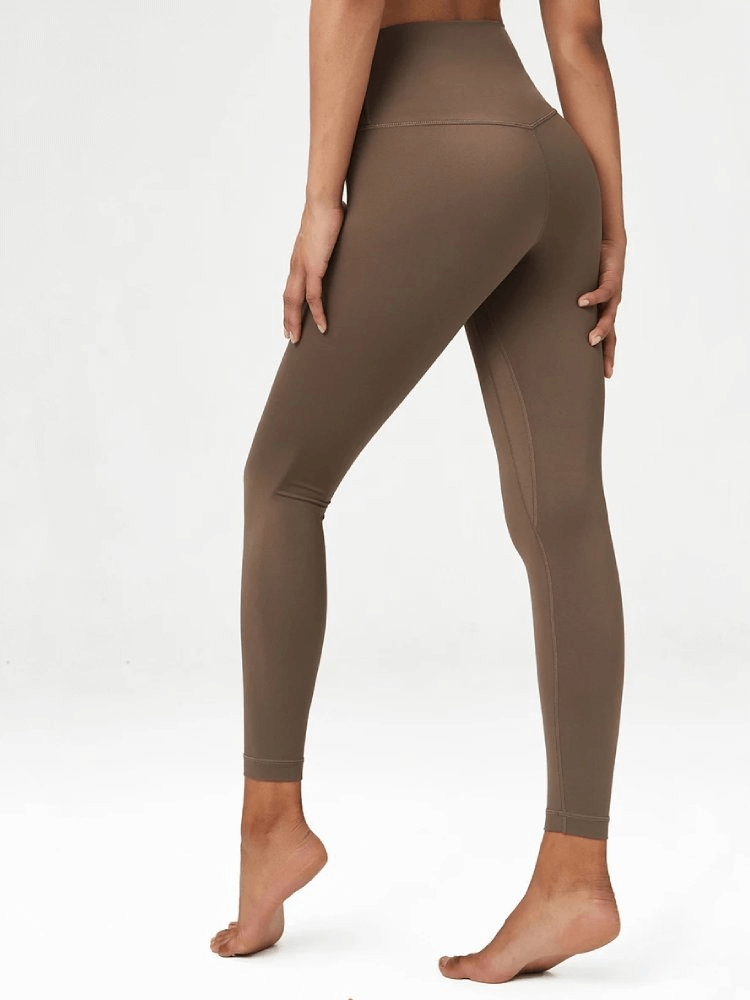 Stylish women's high-waist yoga leggings in brown, featuring elastic fit and durable LYCRA fabric for active lifestyle and casual wear.