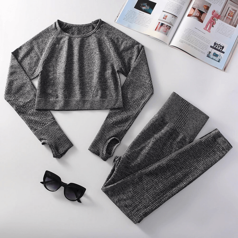 Stylish Elastic Women's Suit in gray with top and leggings for yoga and workouts, alongside open magazines and sunglasses.