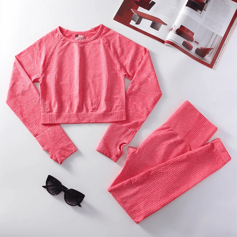 Stylish pink women's elastic suit with top and leggings, perfect for yoga and workouts, made of durable nylon material.