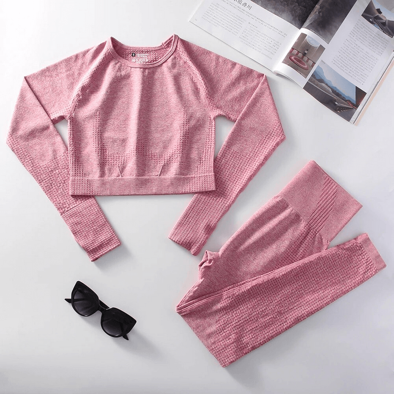 Stylish Elastic Women's Suit SF1683 in pink with top and leggings, designed for yoga, workout sessions, or everyday fashion.