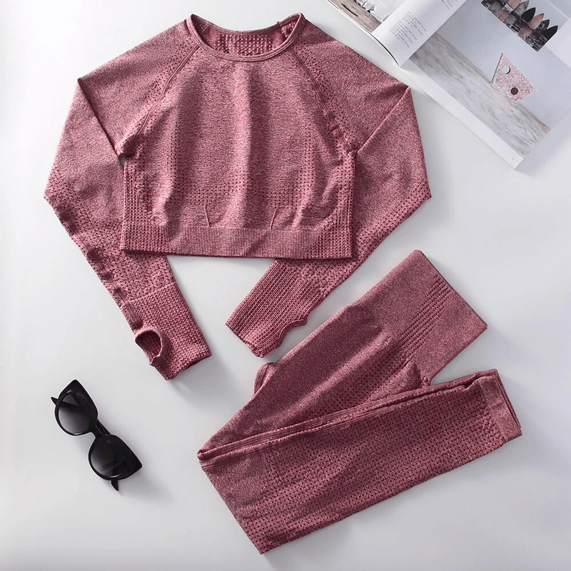 Stylish elastic women's suit in pink with top and leggings, perfect for yoga and workouts, made of durable high-stretch nylon.