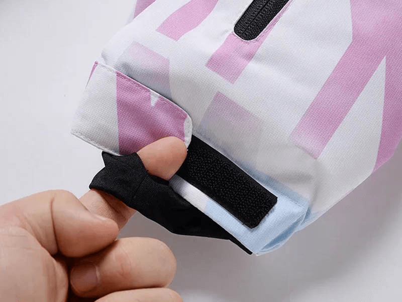 Close-up of Stylish Female Letter Printed Ski Jacket SF1787 cuff detail, showcasing thumb loop and durable pink and white polyester fabric.