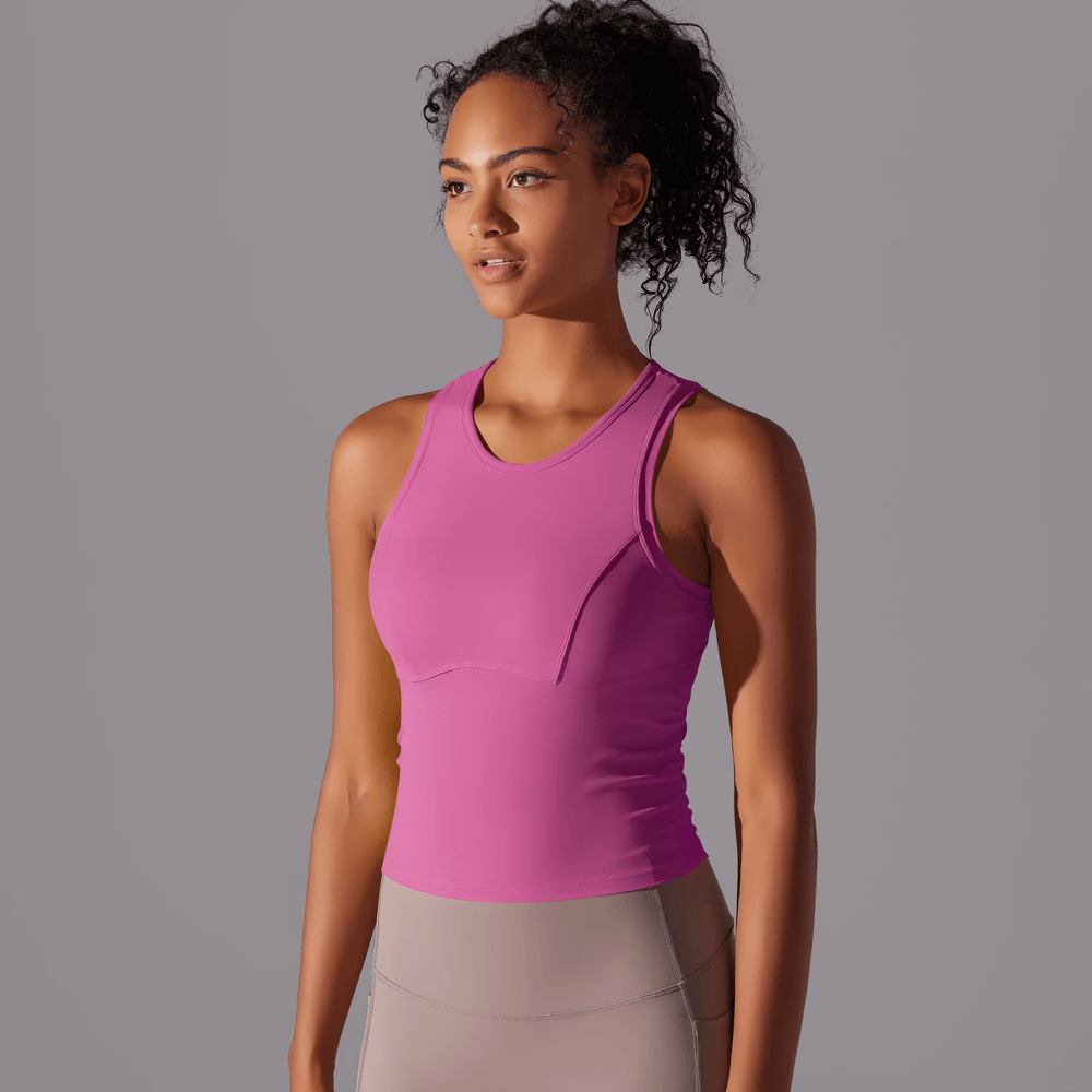 Stylish pink high-impact sports tank top for women, perfect for yoga and intense workouts. Shockproof and supportive design.